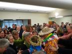 Wearing his new Hawai'ian hat and shirt, Dr. Kratz is engulfed by the congregation.  Photo by Conrad Wesselhoeft