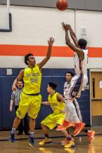 Mandrell Worthy shoots over Andre Moore in a district tournament game.  Eastside Catholic won 79-56.  Worthy had 13 points.