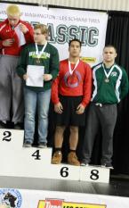 Chief Sealth wrestler, Daron Camacho, stands on the podium, with his sixth place medal around his neck, for his work wrestling in the 195-pound class at state at the Tacoma Dome.