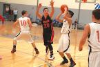 The Lions' Stan Domingo, taking a shot with a Neah Bay player trying to get a hand on  the ball. Photo by Ed Shepherd