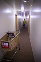 Workmen head down the hall to the worst unit in the building. Photo by Patrick Robinson