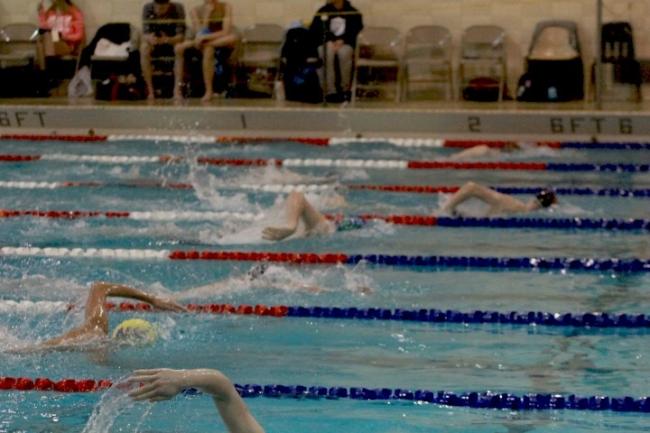 Swimmers swimming in the 2A West Central District swim meet at the Hazen pool.