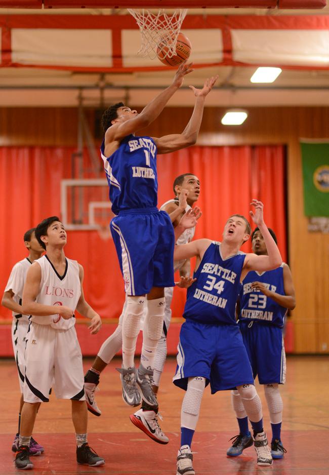 Xavier Turner (11) gets to the rebound before any Shorewood Christian players do.